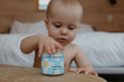 Cute baby with Organic herbal baby diaper balm by Good Flower Farm
