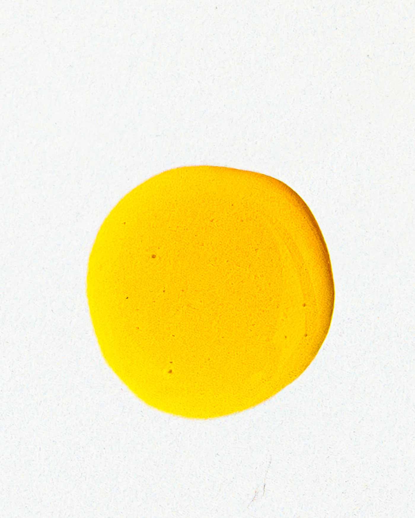 A bright yellow circle on white evokes the natural radiance and hydration of Good Flower Farm’s Golden Glow Facial Serum.