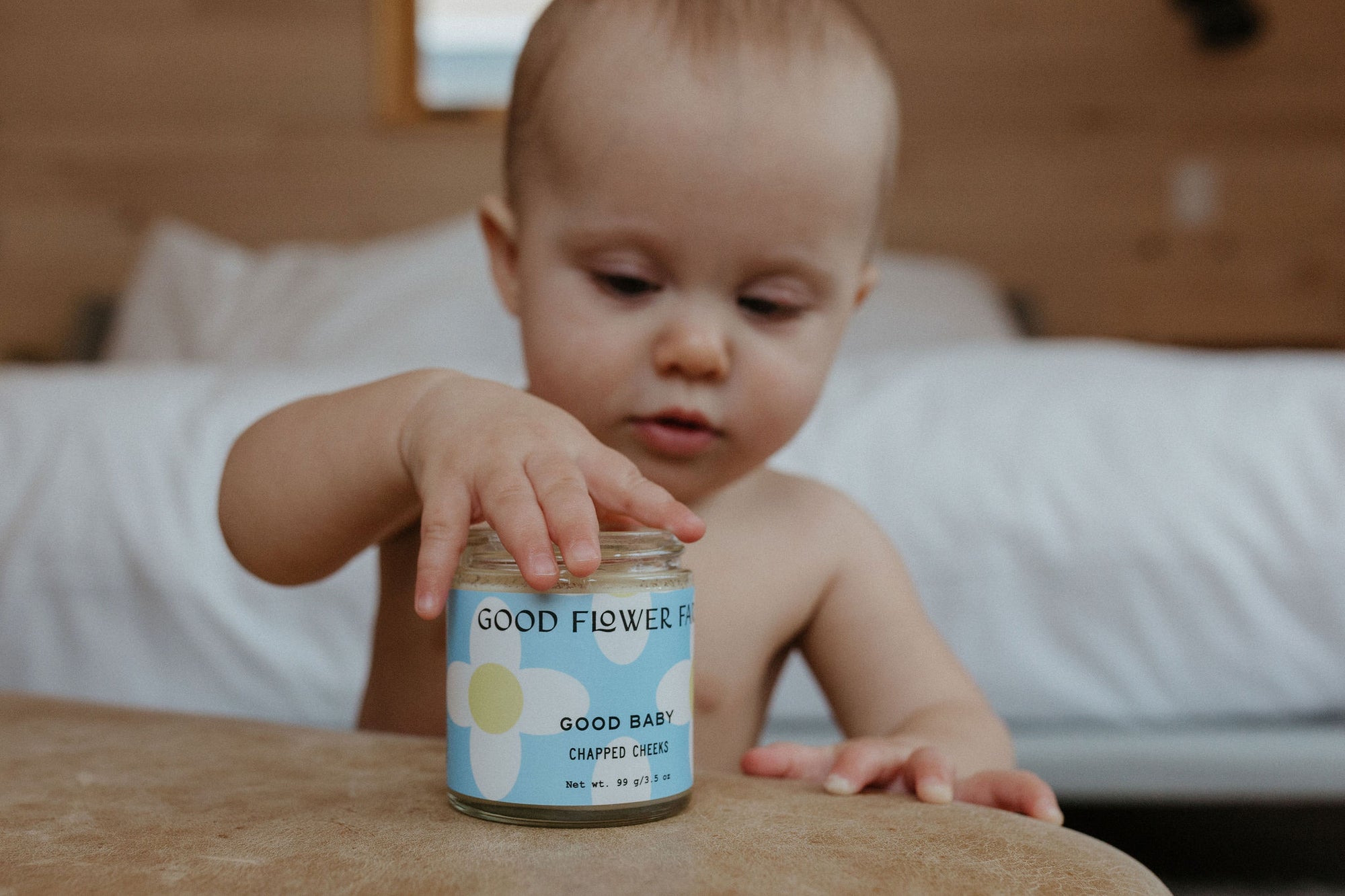 Cute baby with Organic herbal baby diaper balm by Good Flower Farm 