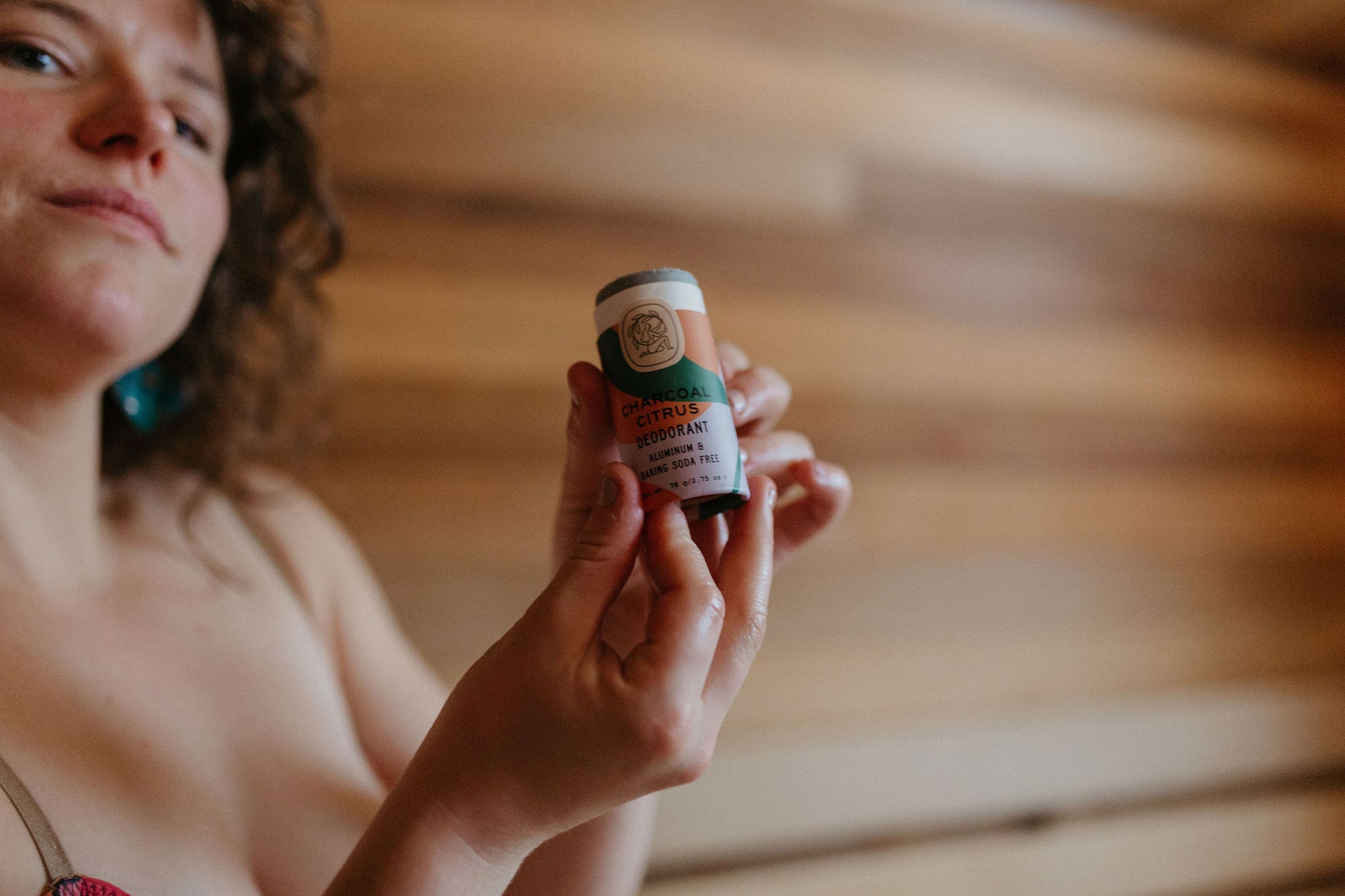 Woman using organic deodorant in sauna