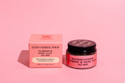 A pink box and a matching jar labeled good-flower-farm Dry Skin Bundle: Save 15% sit side by side on a pink background, promising facial moisturizing benefits for dry skin.