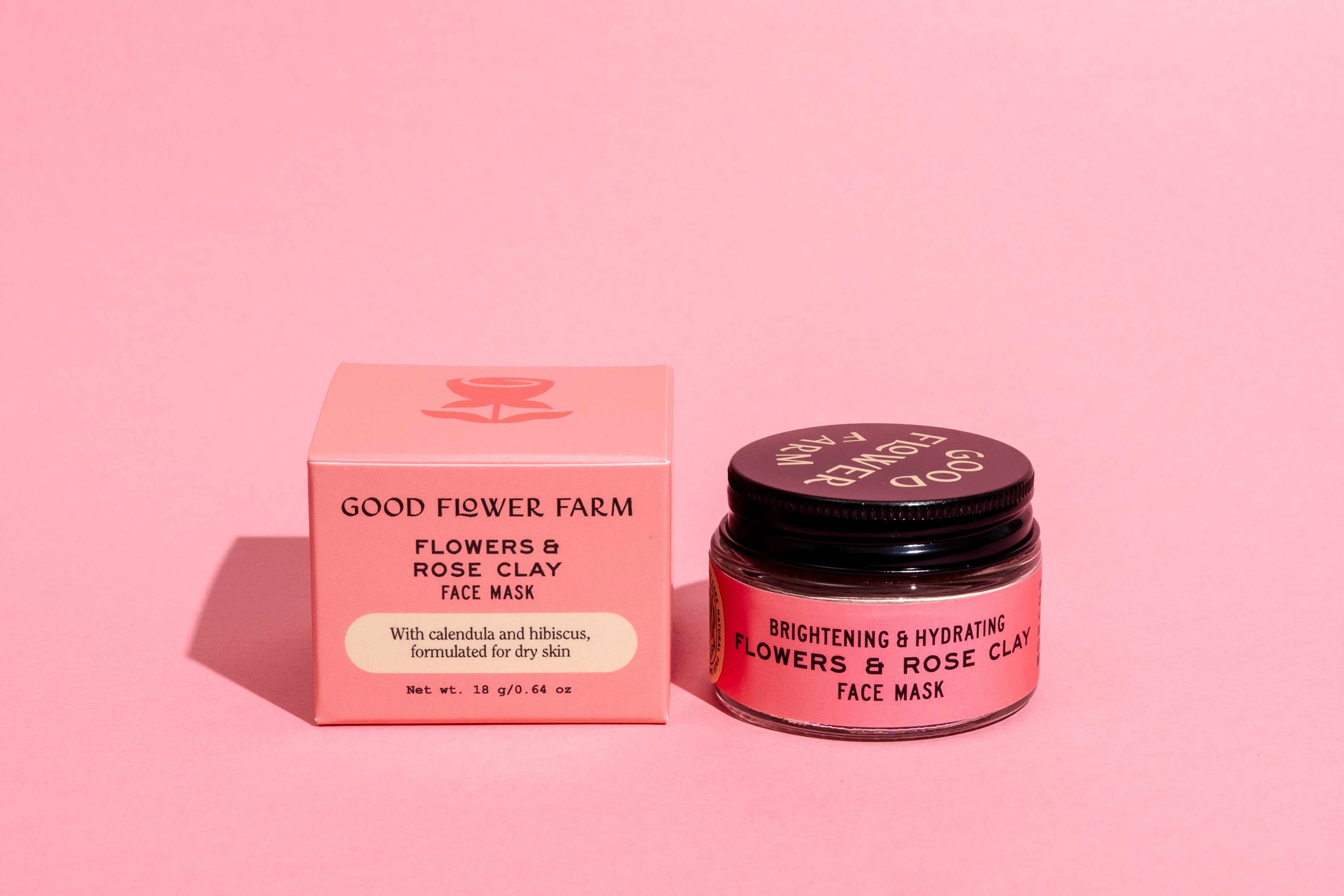 A pink box and a matching jar labeled good-flower-farm Dry Skin Bundle: Save 15% sit side by side on a pink background, promising facial moisturizing benefits for dry skin.