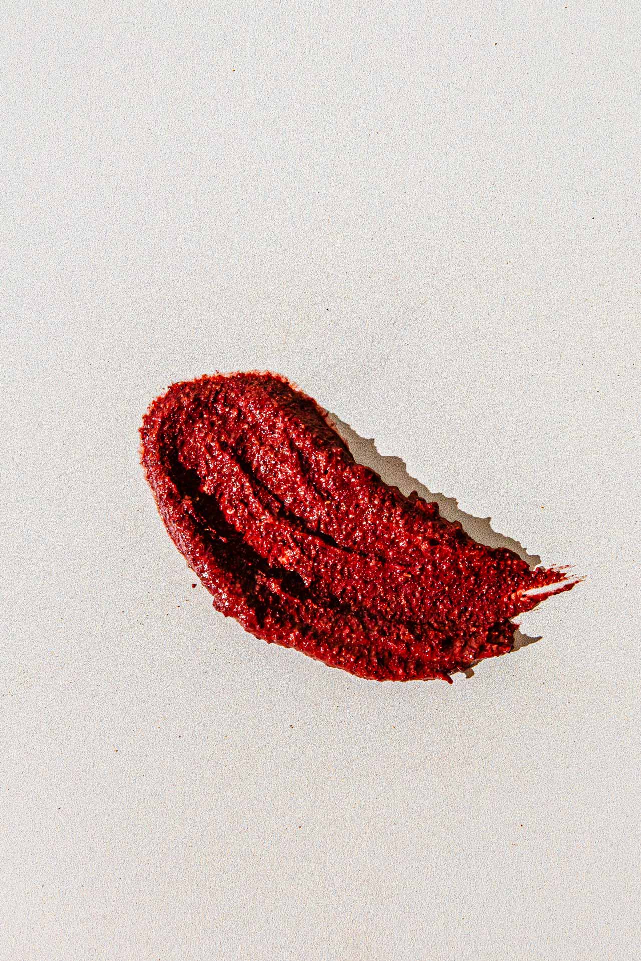 A single textured smear of good-flower-farm’s Dry Skin Bundle is displayed on a plain, off-white background.