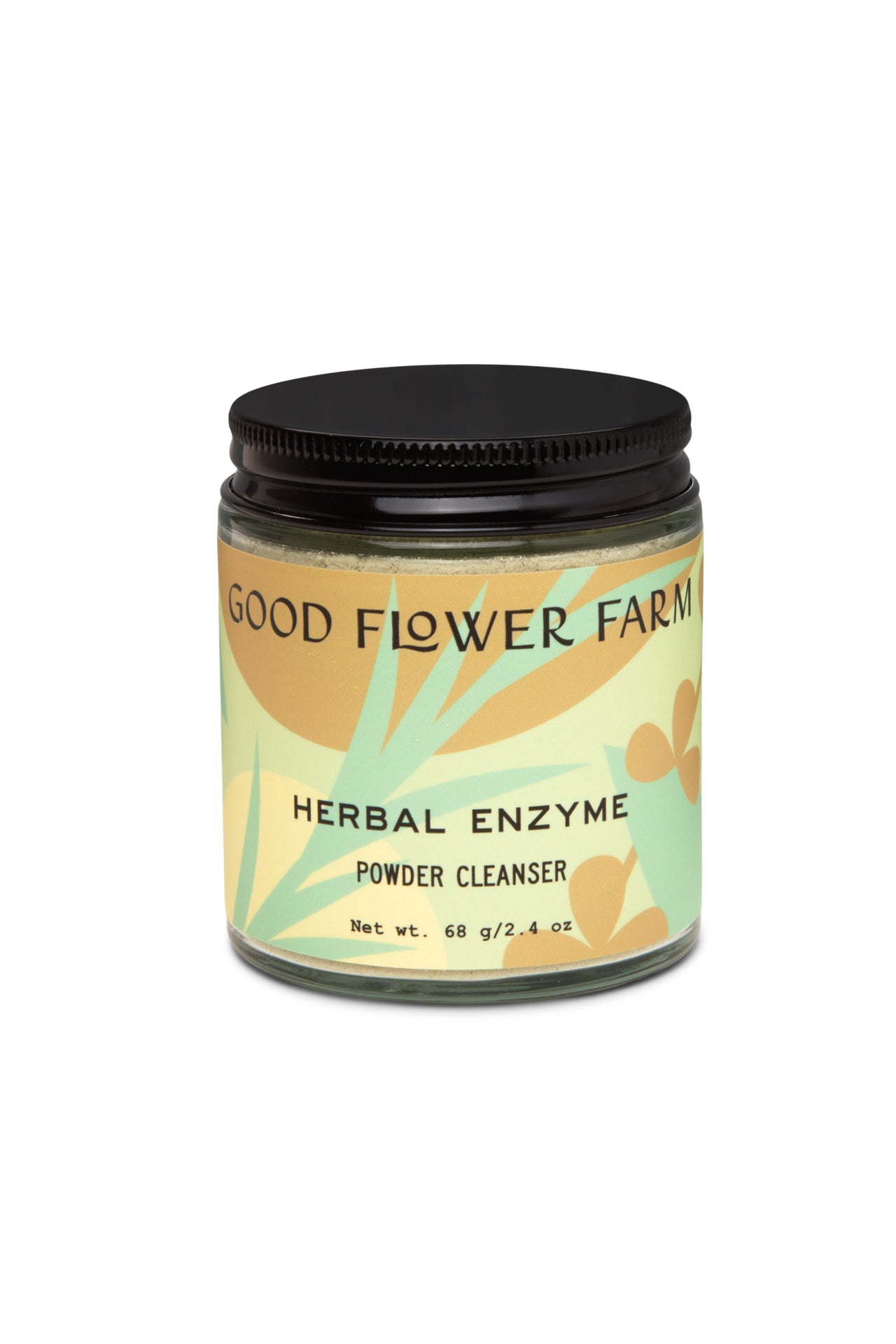 A glass jar labeled Good Flower Farm Herbal Enzyme Powder Facial Cleanser with a black lid. The label has abstract yellow and green floral designs. This 68g (2.4 oz) cleanser gently exfoliates and promotes hydration.