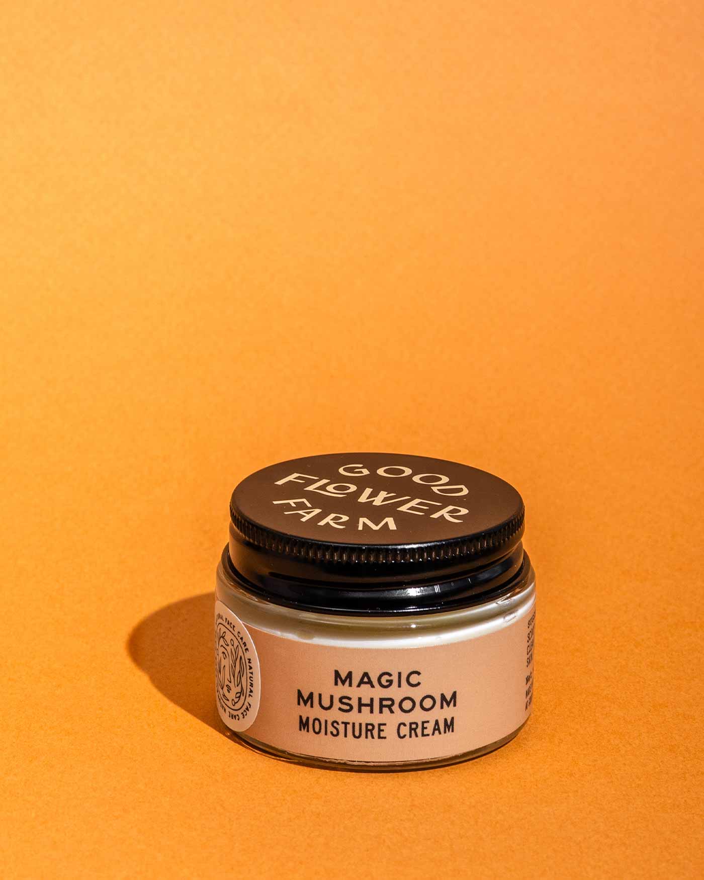 A set from good-flower-farm’s Dry Skin Bundle: Save 15% rests on an orange background with a shadow to the left, ready to deliver soothing moisturizing benefits for dry skin.