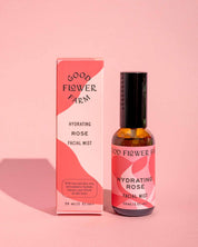A pink bottle and box from the good-flower-farm Seasonal Skincare Bundle are displayed on a pink background, with a shadow to the left.