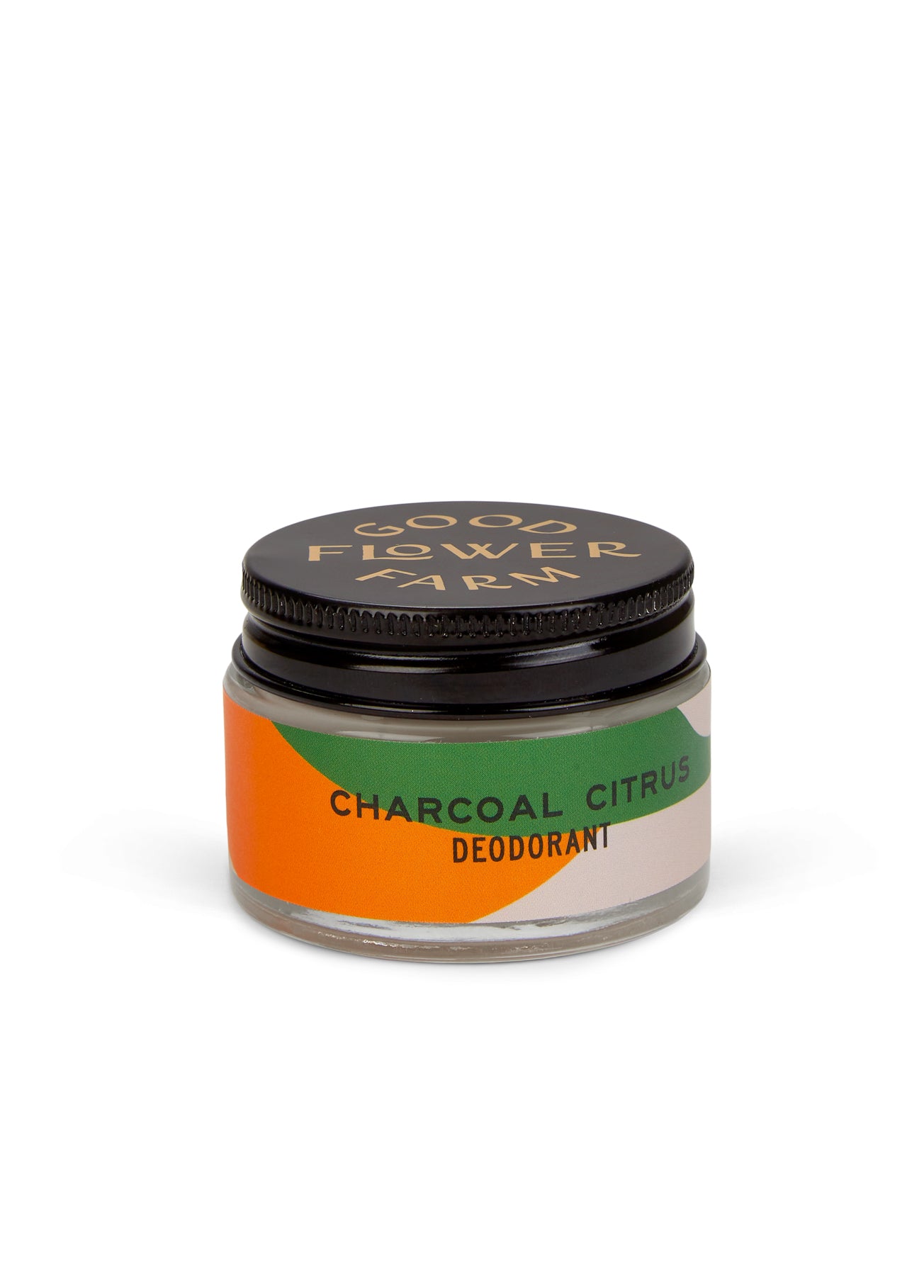 A small glass jar of Good Flower Farm Charcoal Citrus Deodorant with a bamboo applicator, featuring a black lid and an orange, green, and beige label—aluminum free and gentle for sensitive skin.