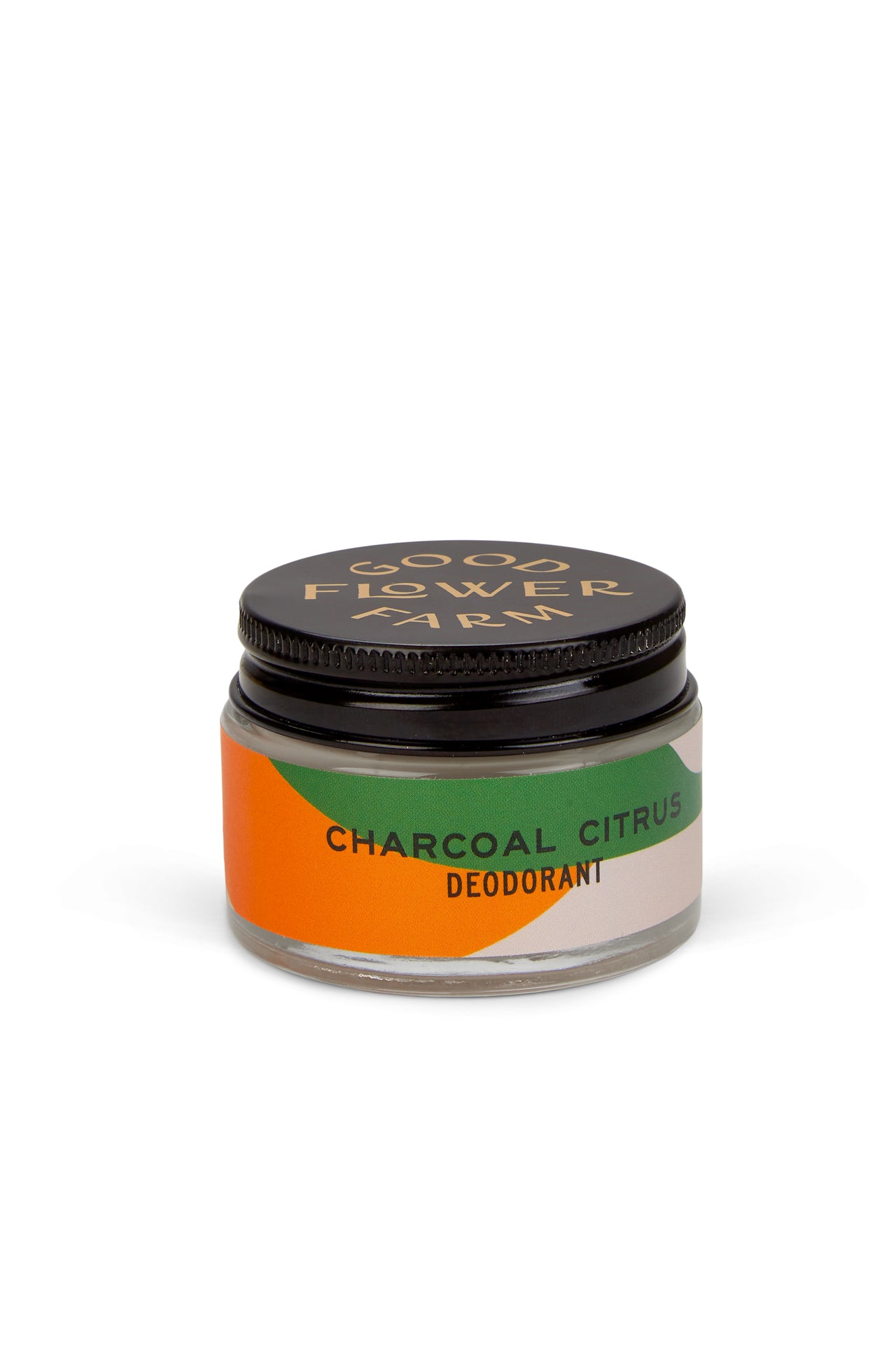 A small glass jar of Good Flower Farm Charcoal Citrus Deodorant with a bamboo applicator, featuring a black lid and an orange, green, and beige label—aluminum free and gentle for sensitive skin.