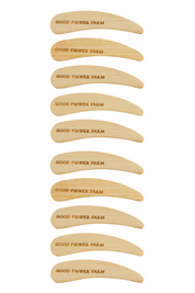 The Reusable Bamboo Spatula - Set of 5 or 10 by Good Flower Farm features identical, washable spatulas engraved in uppercase with the brand name. The spatulas are arranged vertically in the product display.